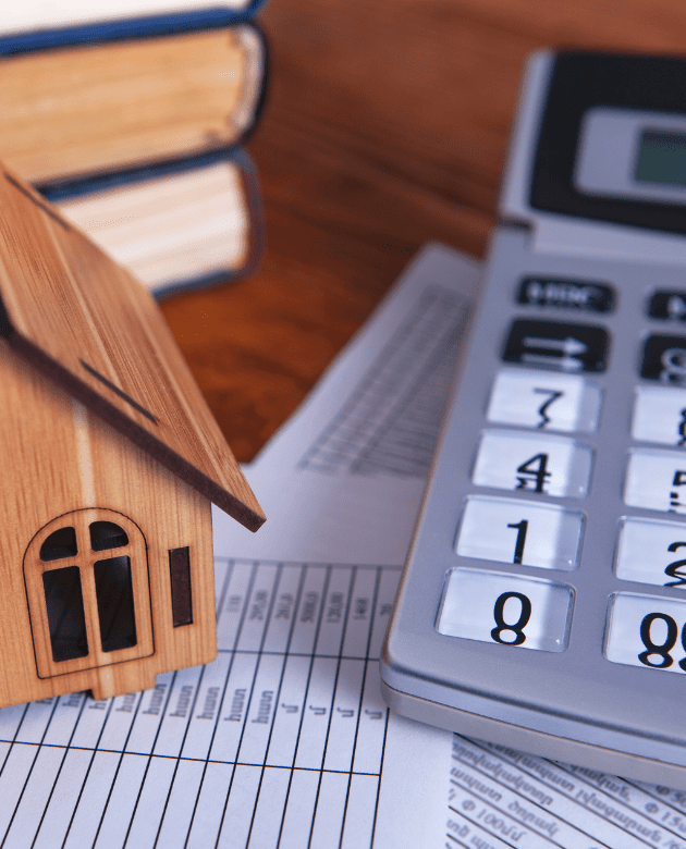 a calculator and wooden house