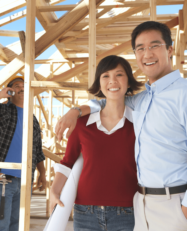 Happy couple at construction site