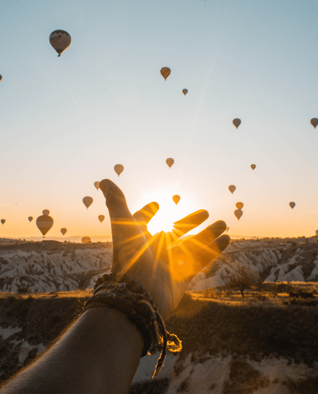 Hand reaching out to the light, achieving financial dreams and goals